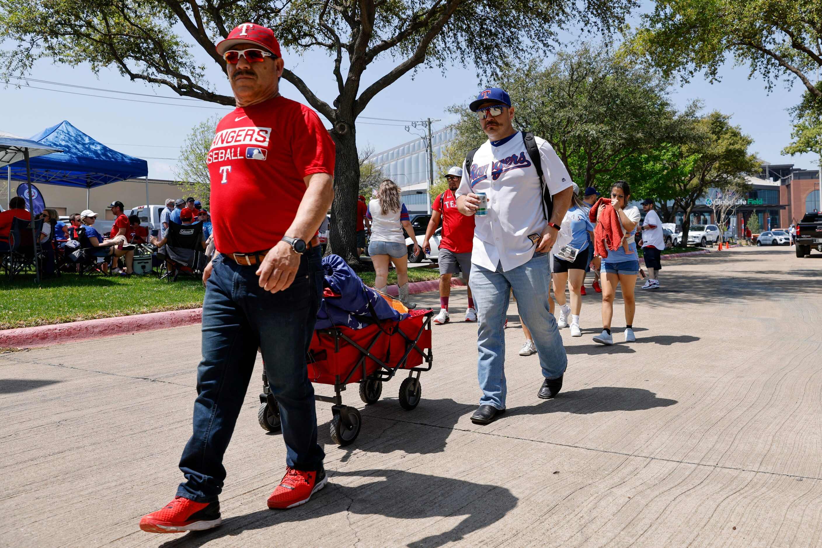 Texas Rangers fans head to a tailgate before the home opener against the Colorado Rockies at...