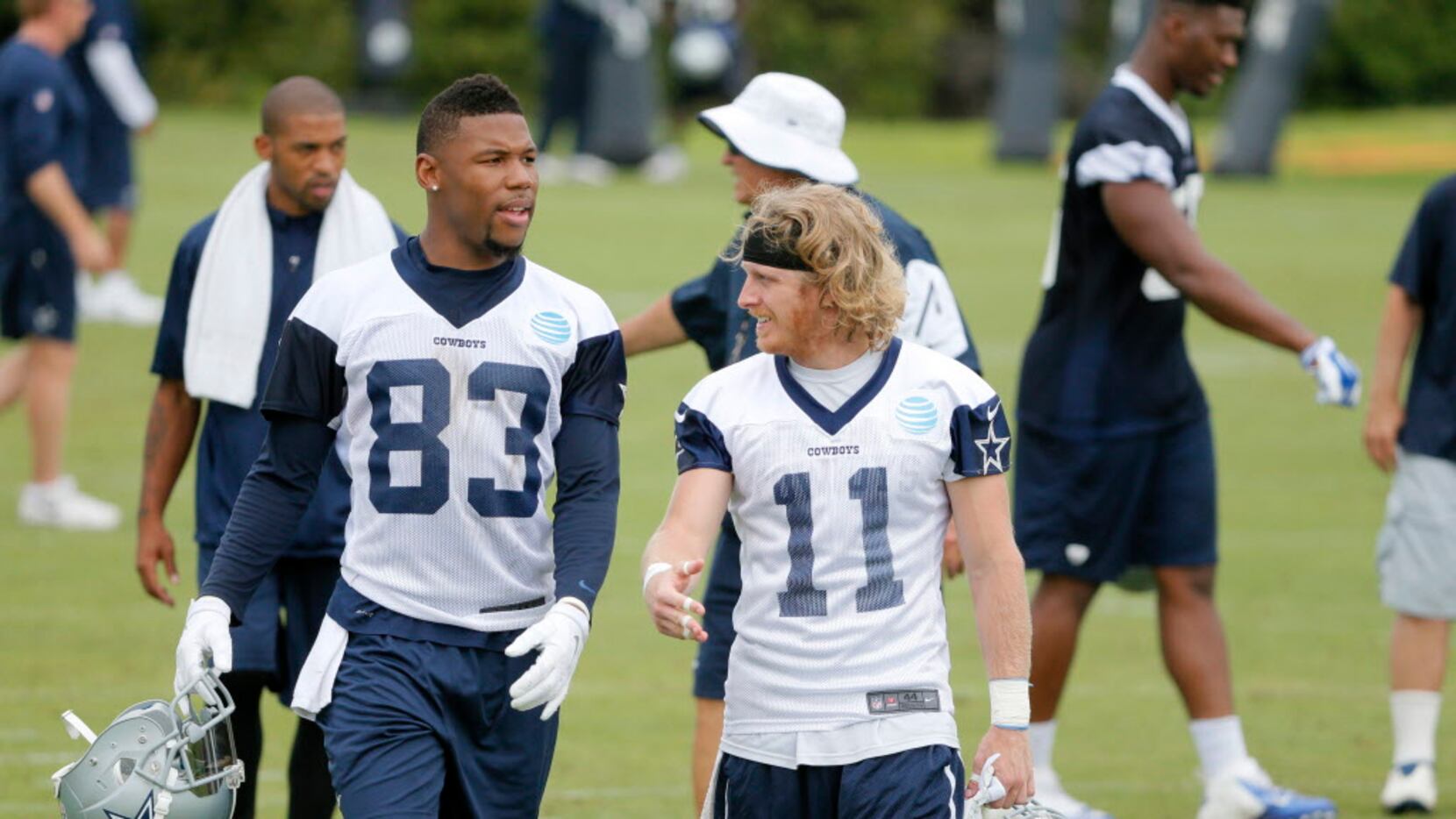 Dallas Cowboys wide receiver Terrance Williams (83) and wide receiver Cole Beasley (11) walk...