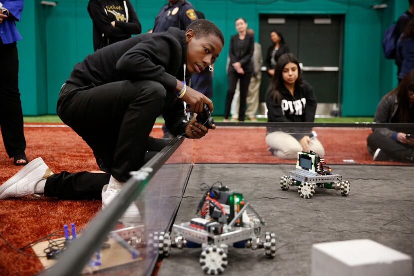 Jacari Westbrook, a freshman at L.G. Pinkston High School controls a robot during a grant...