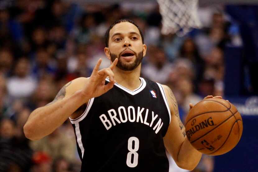 Brooklyn Nets' player Deron Williams communicates with his teammates during a game between...