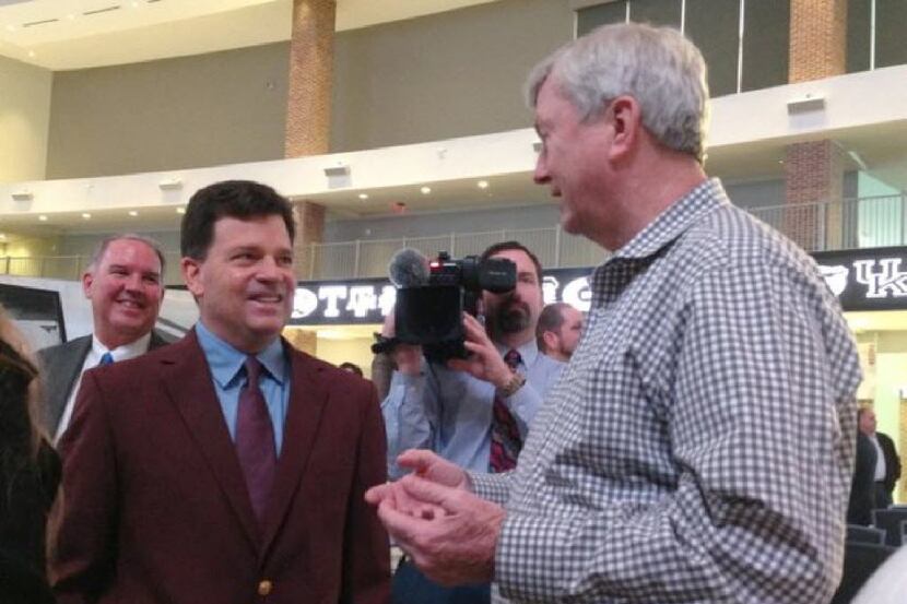 New Texas A&M athletic director Scott Woodward (left) visits with women's basketball coach...
