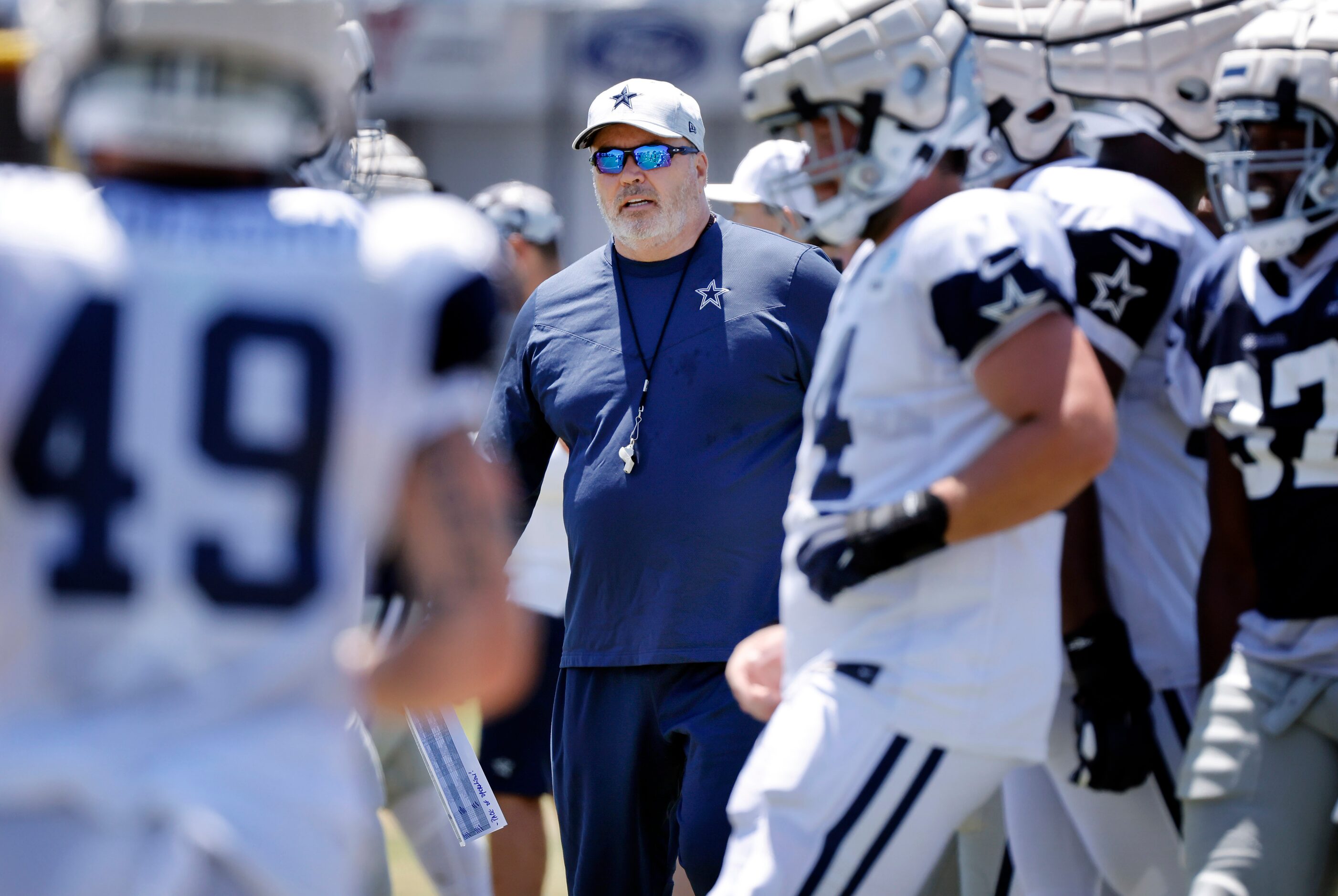 Dallas Cowboys head coach Mike McCarthy watches the offense run plays during training camp...