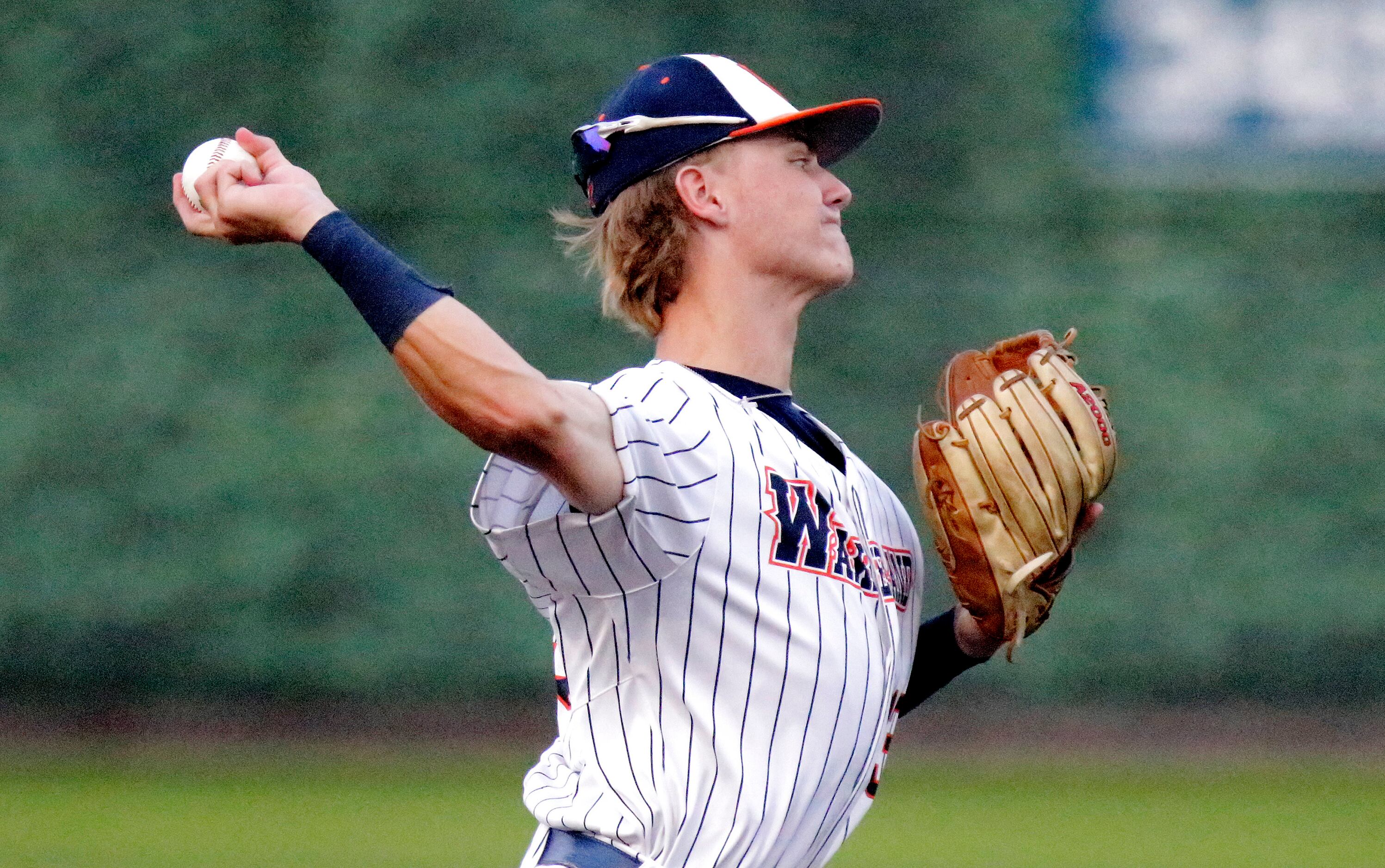 Wakeland High School shortstop Will Jameson (13) makes a throw for an out in the third...