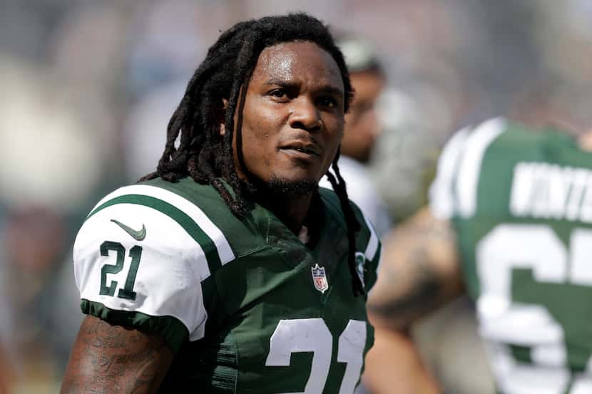 In this Sept. 28, 2014, file photo, New York Jets running back Chris Johnson warms up before...