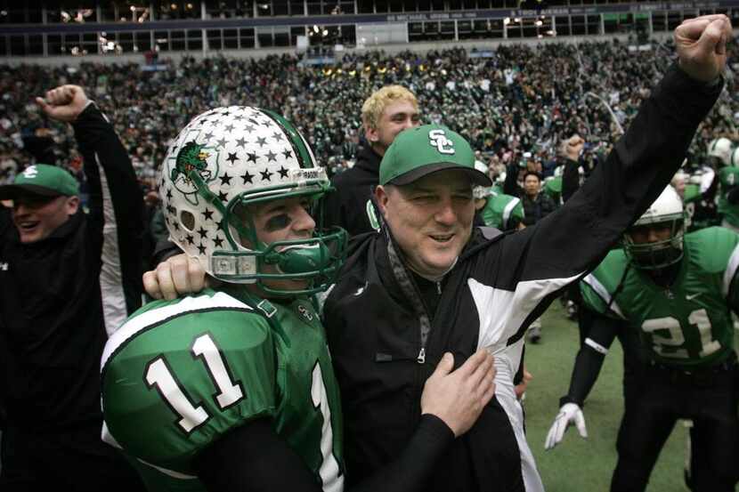 Southlake Carroll head coach Todd Dodge (right) and his sophmore son Riley Dodge (11)...