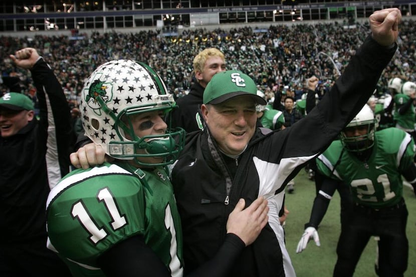 Southlake Carroll head coach Todd Dodge (right) and his sophmore son Riley Dodge (11)...