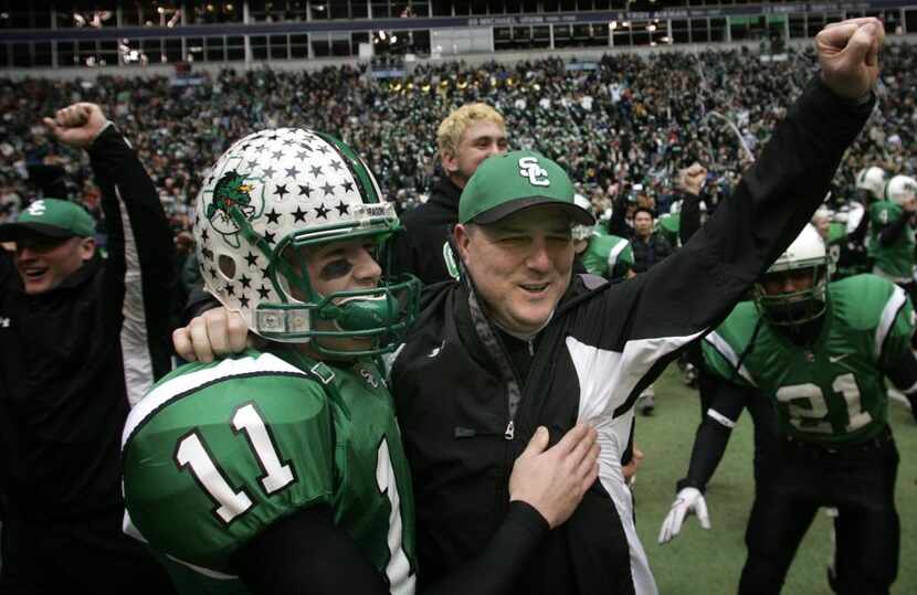 Southlake Carroll head coach Todd Dodge (right) and his sophmore son Riley Dodge (11)...