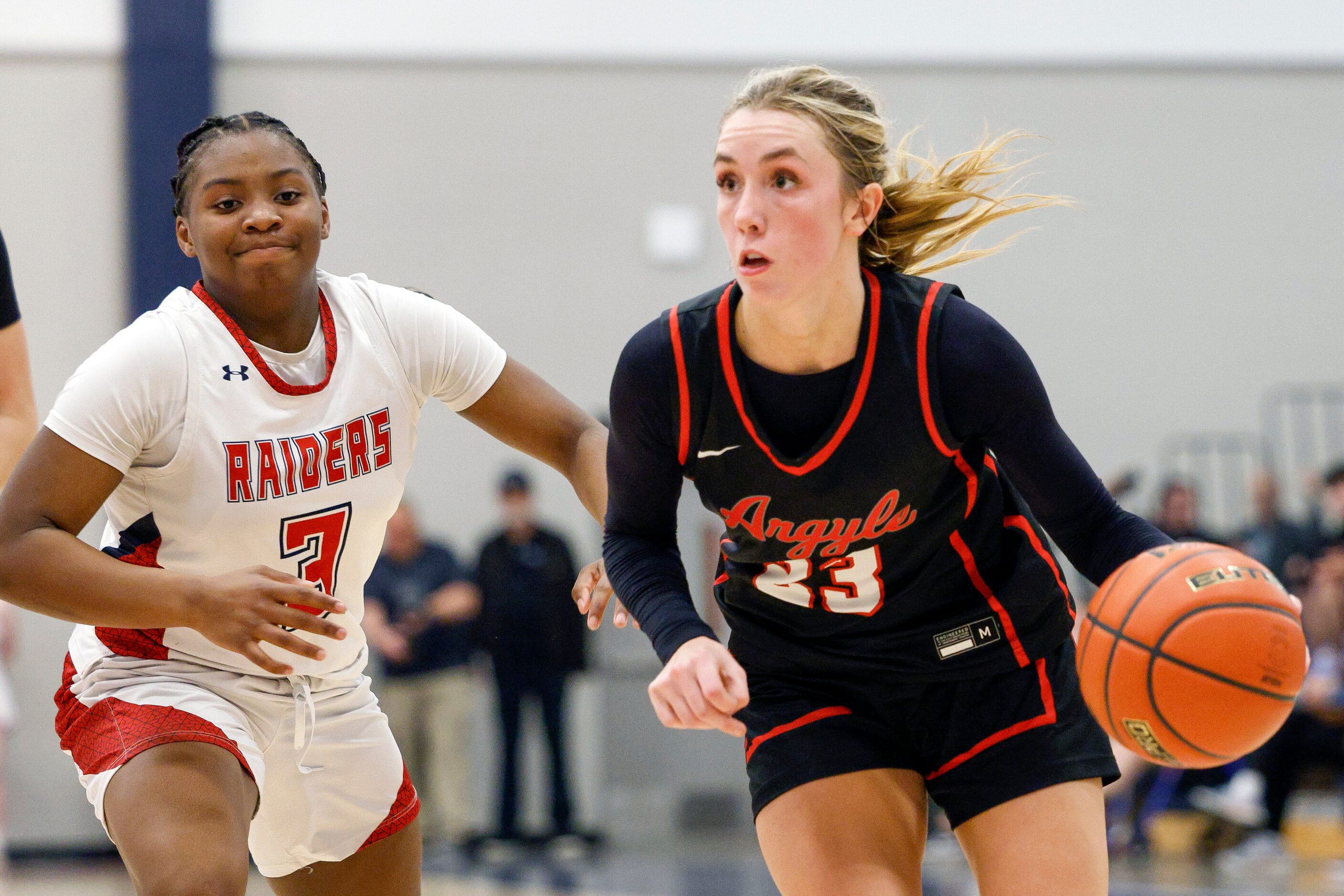 Argyle guard Kennedy Hafer (23) dribbles past Denton Ryan guard Atiya Everett (3) during...