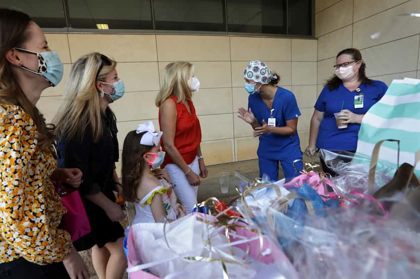 Volunteers deliver bags of goodies to health care workers at Parkland Hospital in Dallas on...