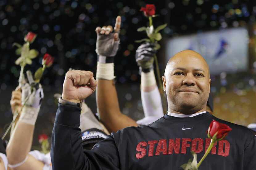 Stanford head coach David Shaw holds a rose after the NCAA Pac-12 Championship football...