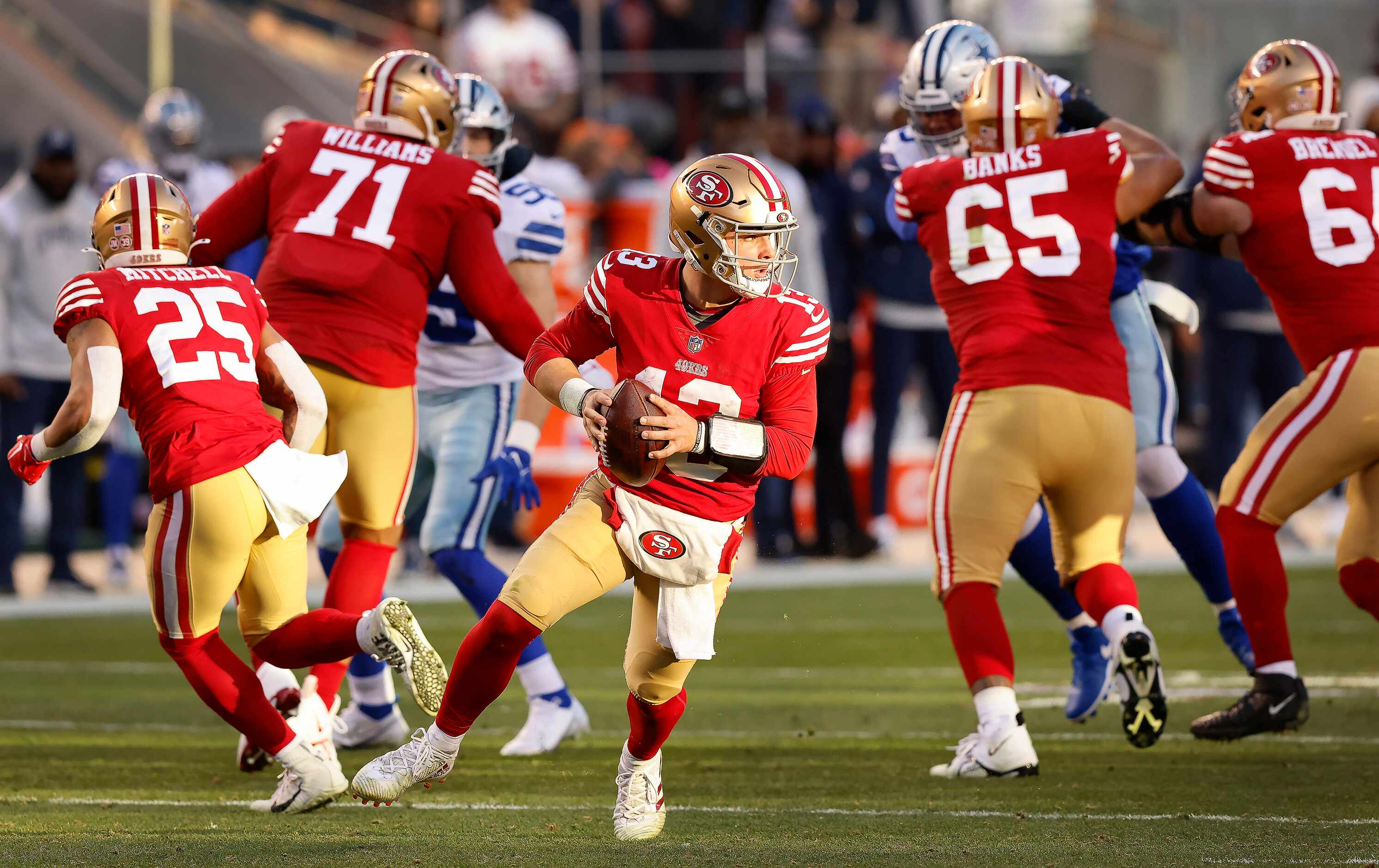 San Francisco 49ers quarterback Brock Purdy (13) rolls out in the second quarter looking for...