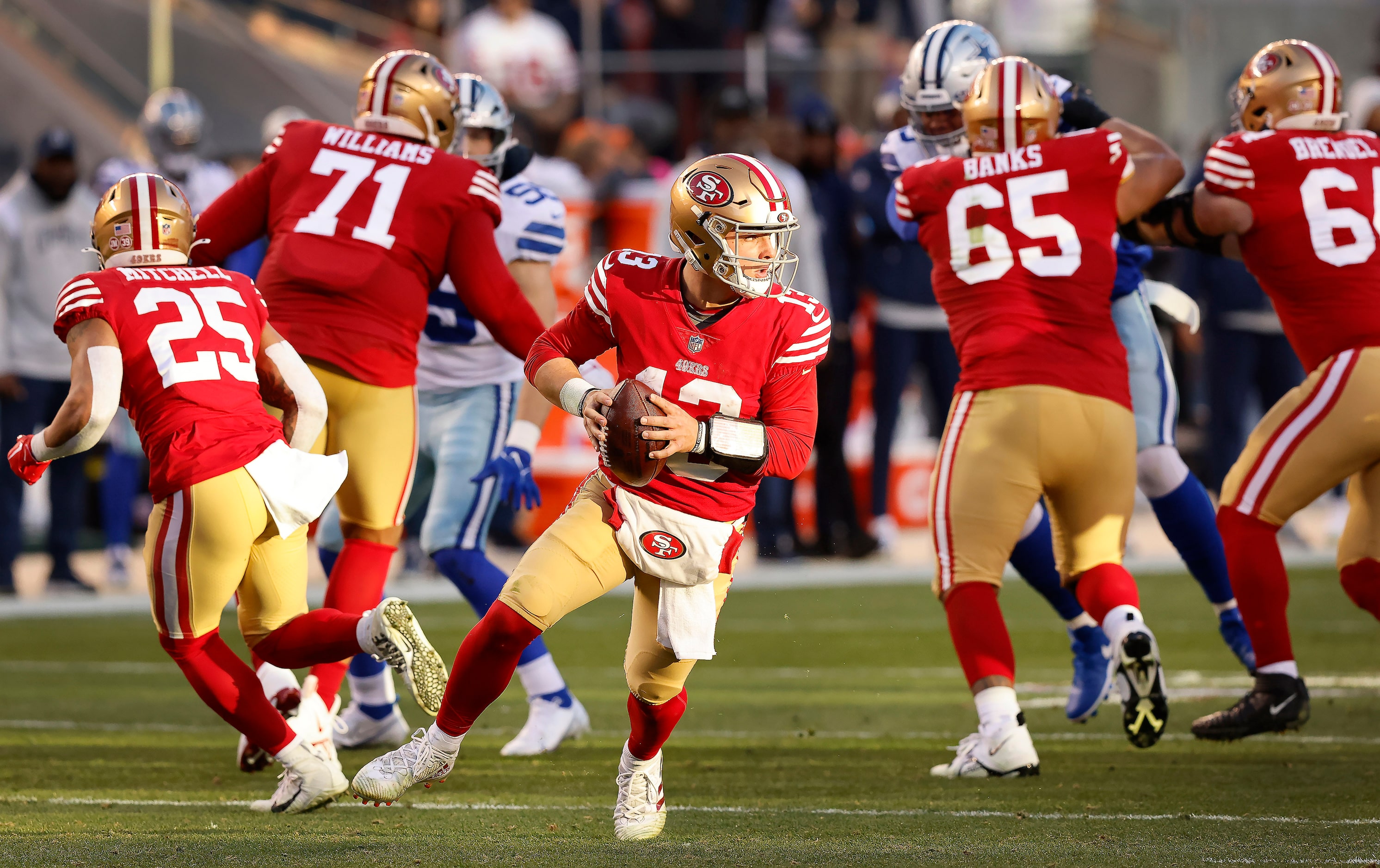 San Francisco 49ers quarterback Brock Purdy (13) rolls out in the second quarter looking for...