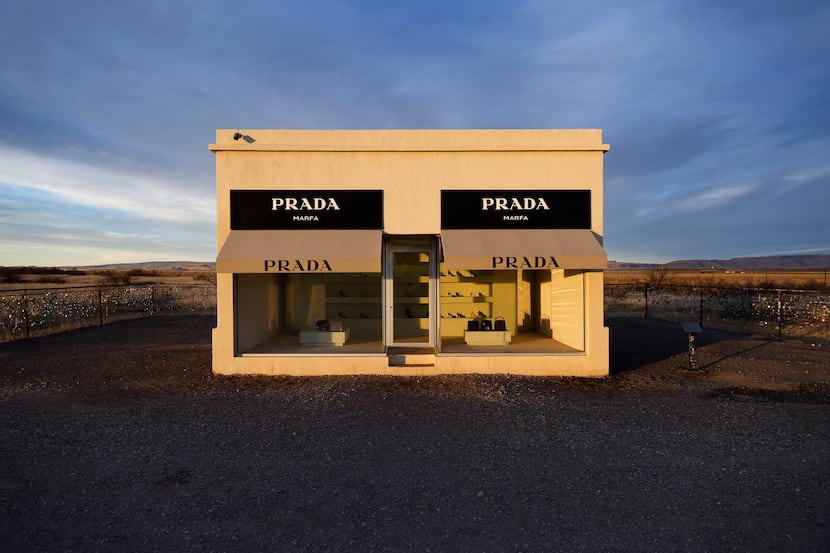 The sun rises on the permanent art installation of Prada Marfa along U.S. Route 90...