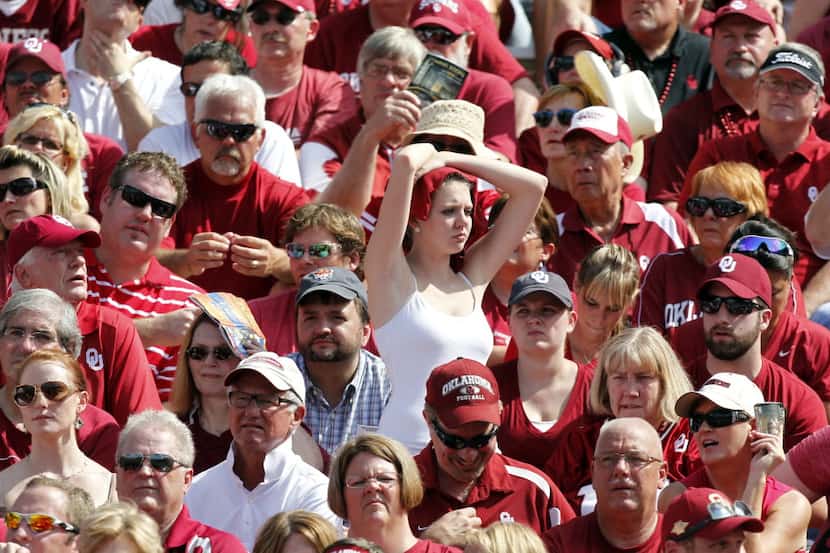 Oklahoma Sooners fans try to avoid the heat during the second half of the Red River Rivalry...