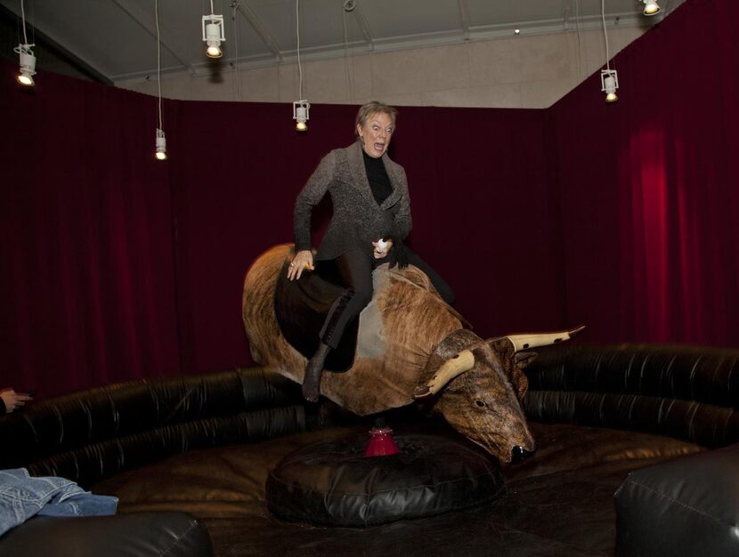 
Nancy Whitenack rides the mechanical bull installed temporarily inside the Nasher Sculpture...