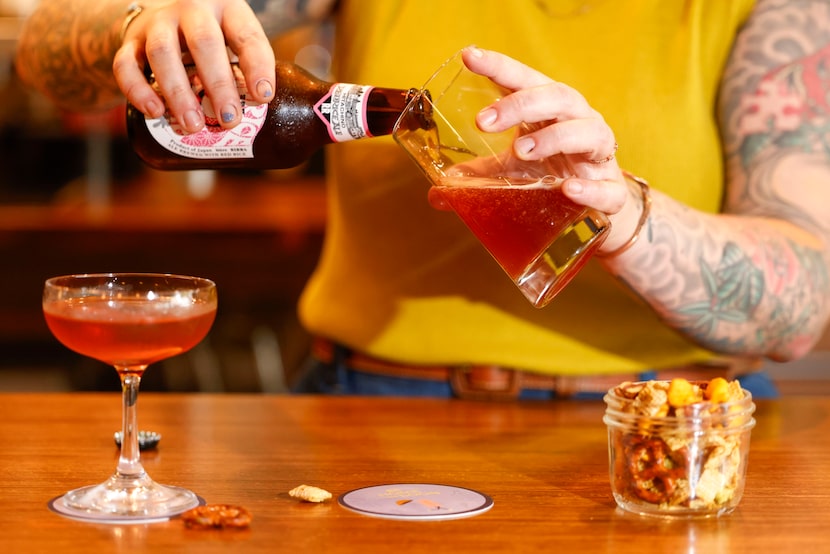 Madison King, co-owner and executive chef of Be Home Soon, pours a drink at the new restaurant