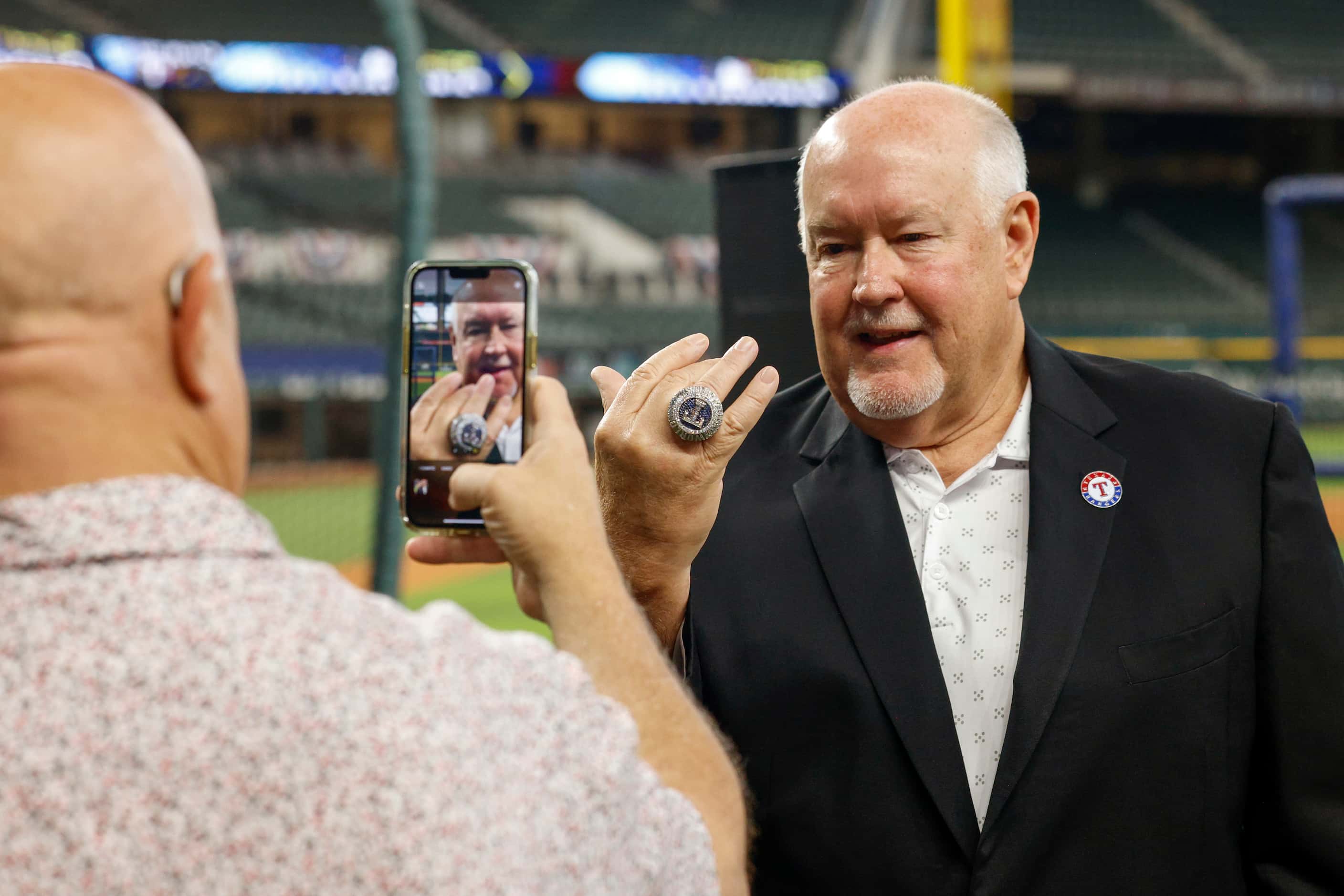 The Dallas Morning News Texas Rangers reporter Evan Grant takes a picture of Chuck Morgan’s,...