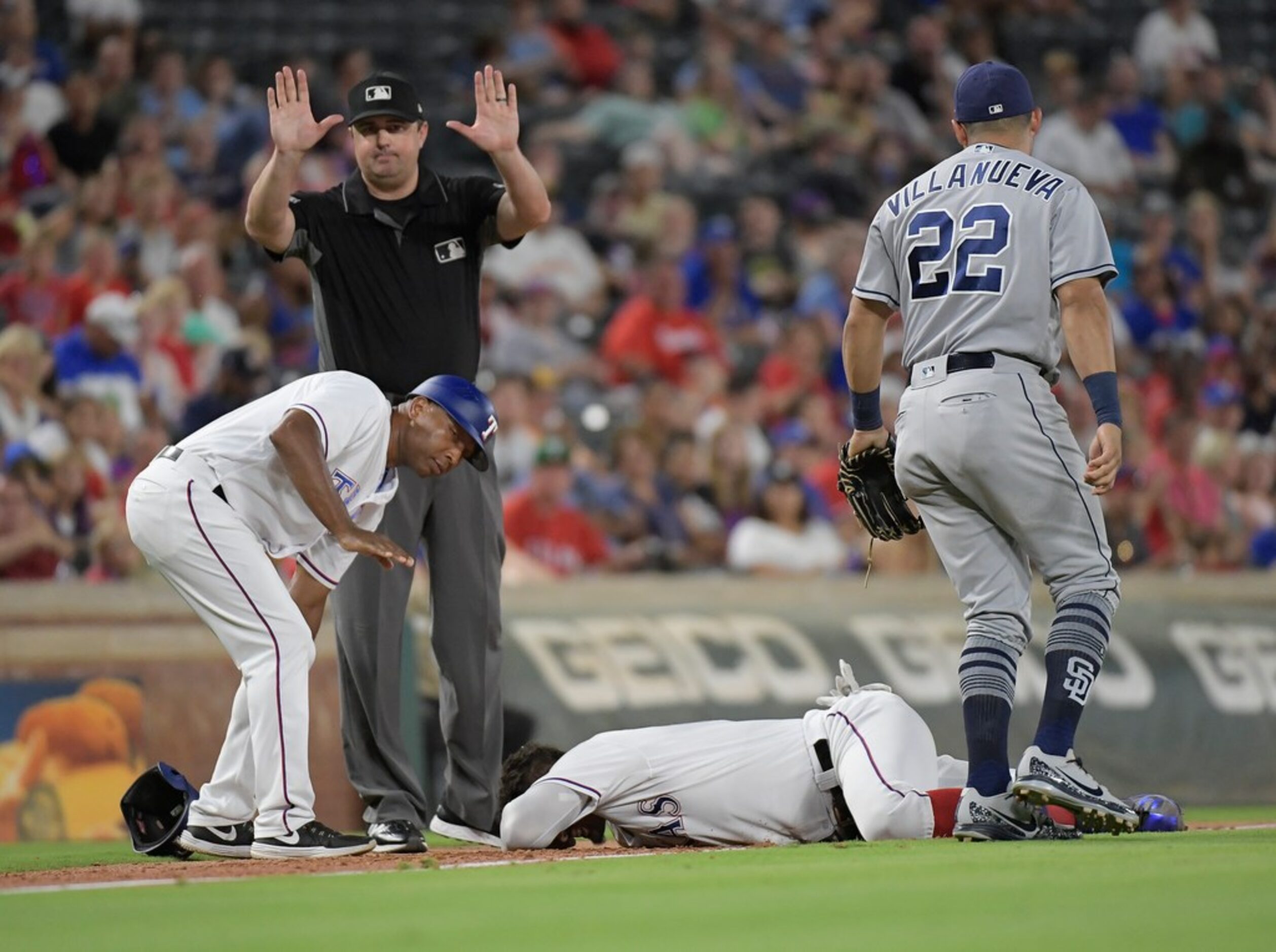 Texas Rangers first baseman Ronald Guzman (67) is injured on a pick off attempt at third...