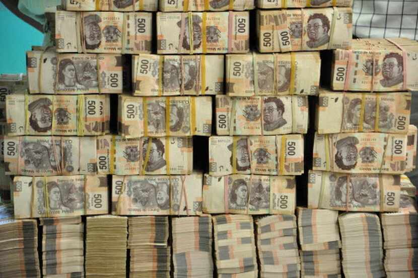 
Bundles of 500 peso bills were found at the offices of a former state official in Mexico in...