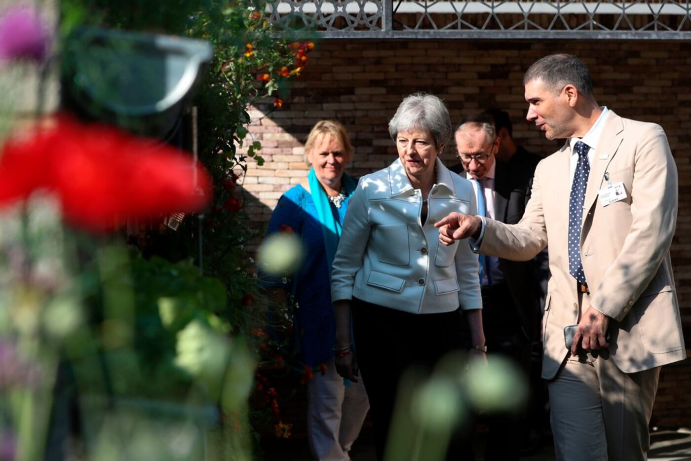 Britain's Prime Minister Theresa May is shown around the Lemon Tree Trust Garden by the...