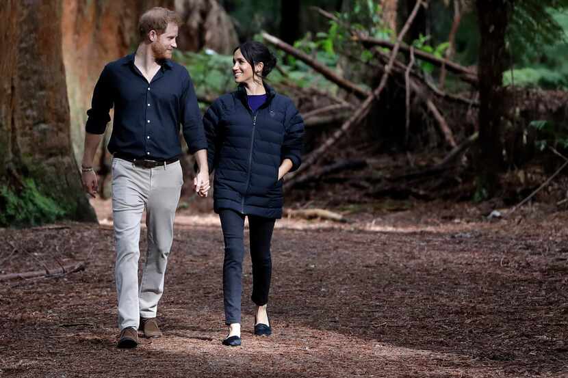 Britain's Prince Harry and Meghan, Duchess of Sussex, walk through a redwood forest in...