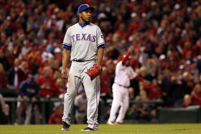 Neftali Feliz #30 of the Texas Rangers reacts after giving up a game tying two-run RBI...