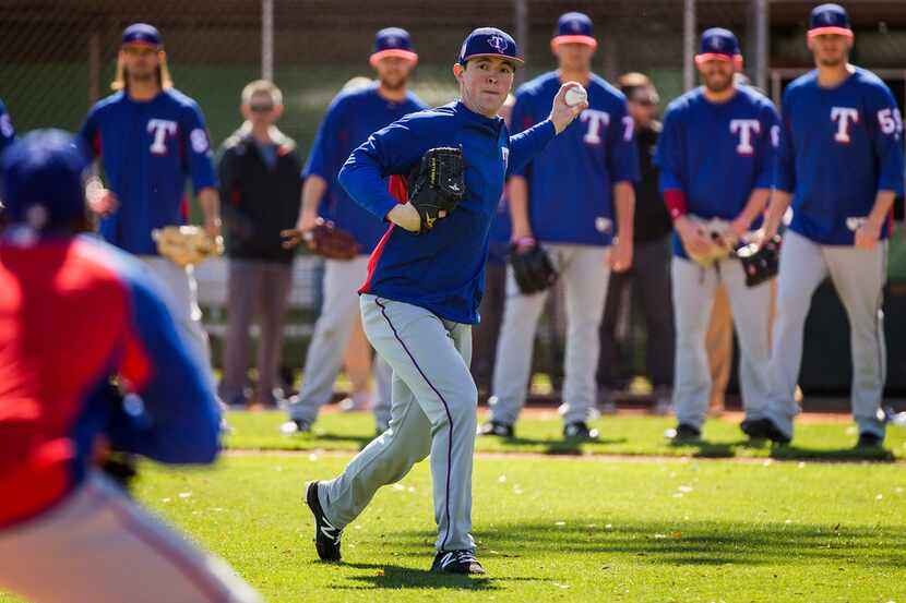Texas Rangers pitcher Jeffrey Springs participates in a fielding drill during the first...