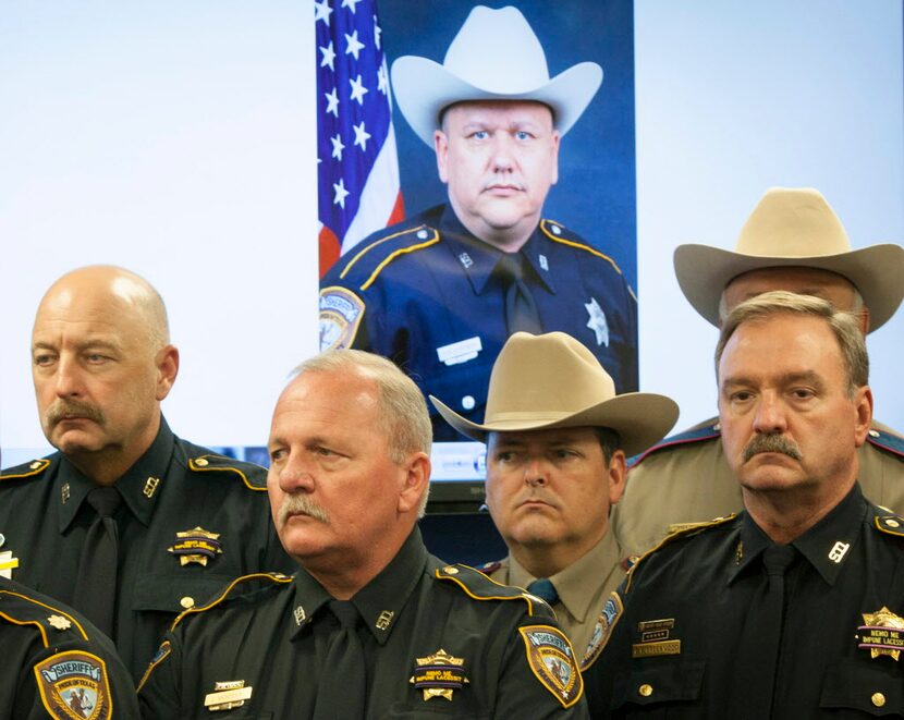 
Law enforcement officers attend a news conference on the shooting death of Harris County...