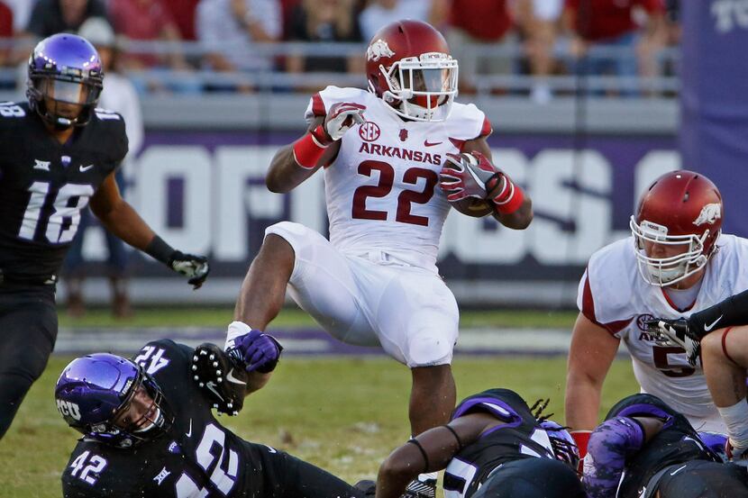 Arkansas running back Rawleigh Williams III (22) is brought down by the ankles by the TCU...