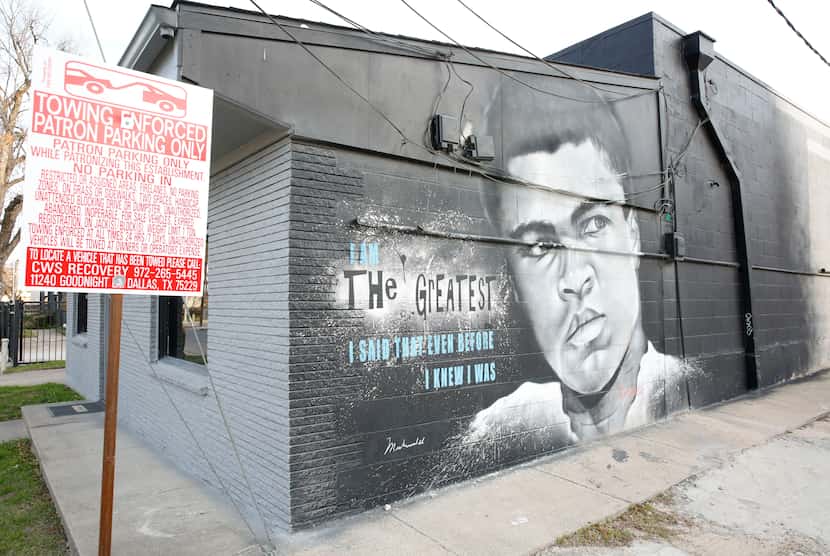A mural of Muhammad Ali painted by Theo Ponchaveli was on the side of a building off...