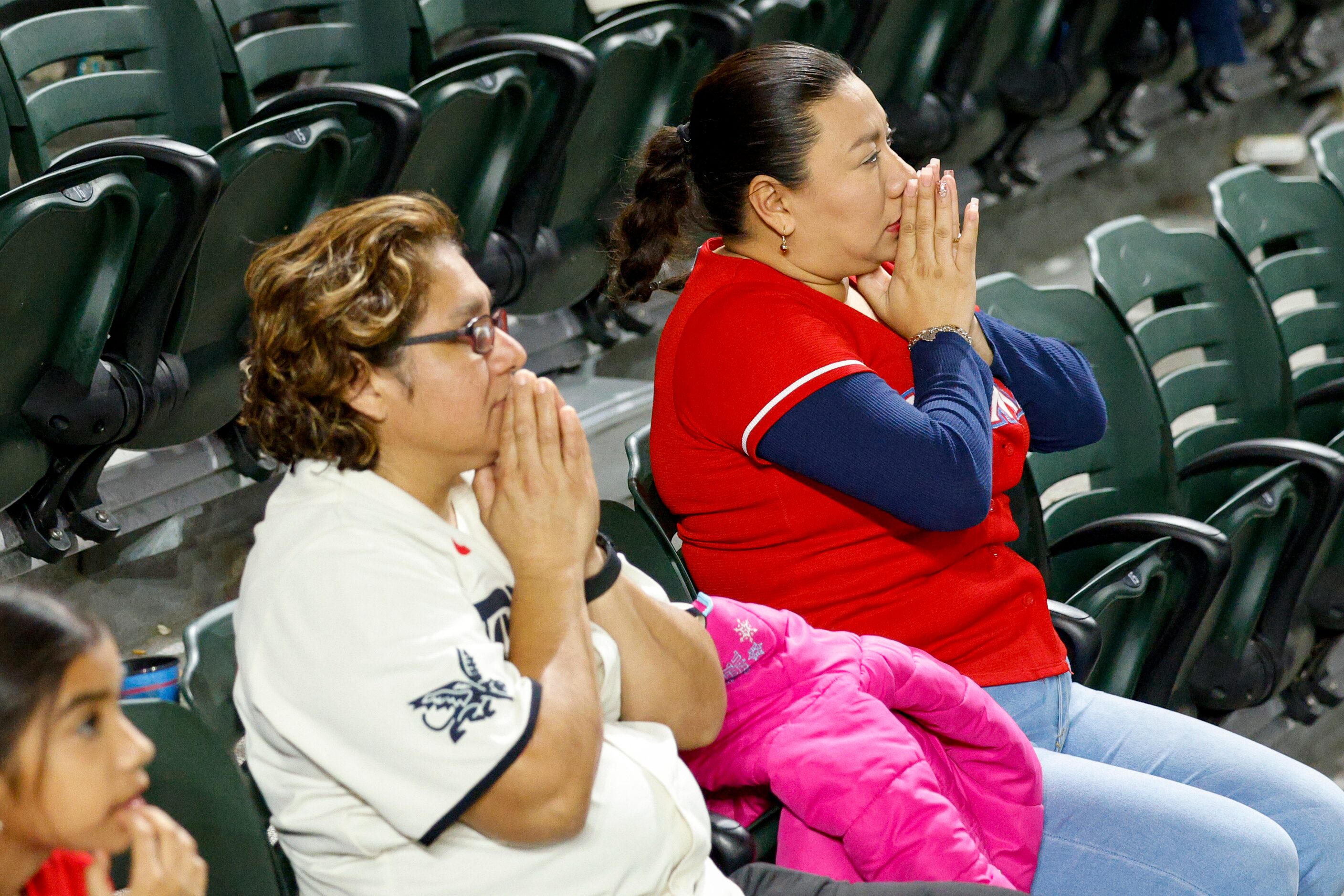 Marissa Castillo (left) and Lucero Hernandez of Fort Worth watch nervously as Texas Rangers...