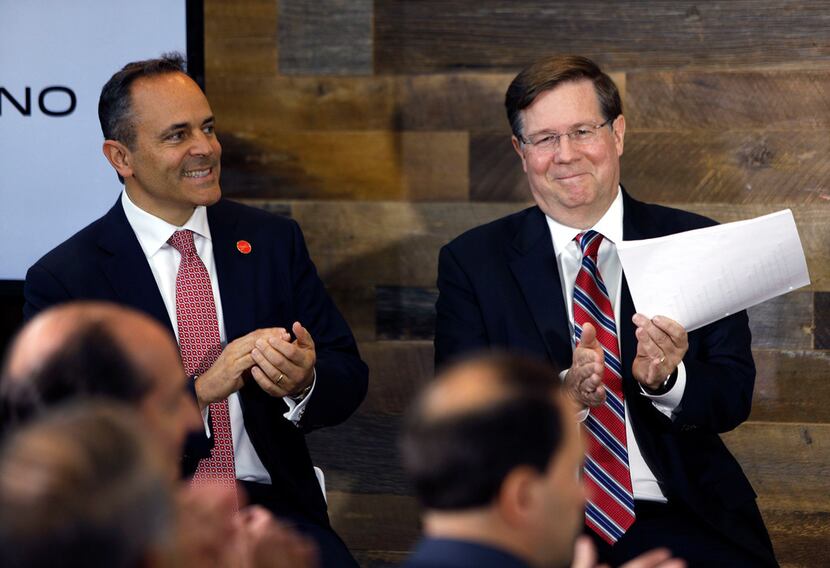 Toyota CEO Jim Lentz (right) and Kentucky Gov. Matt Bevin (left) applaud a speaker at the...