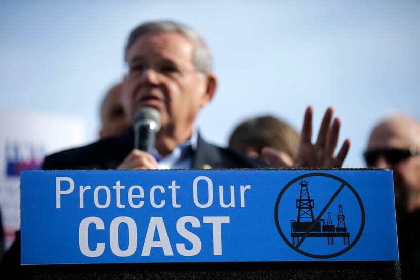 Democratic U.S. Sen. Bob Menendez stands behind a Protect Our Coast sign, as he addresses a...