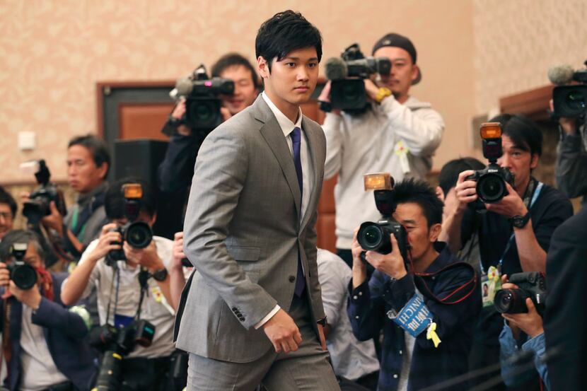 Japanese pitcher-outfielder Shohei Ohtani arrives for a press conference at Japanese...