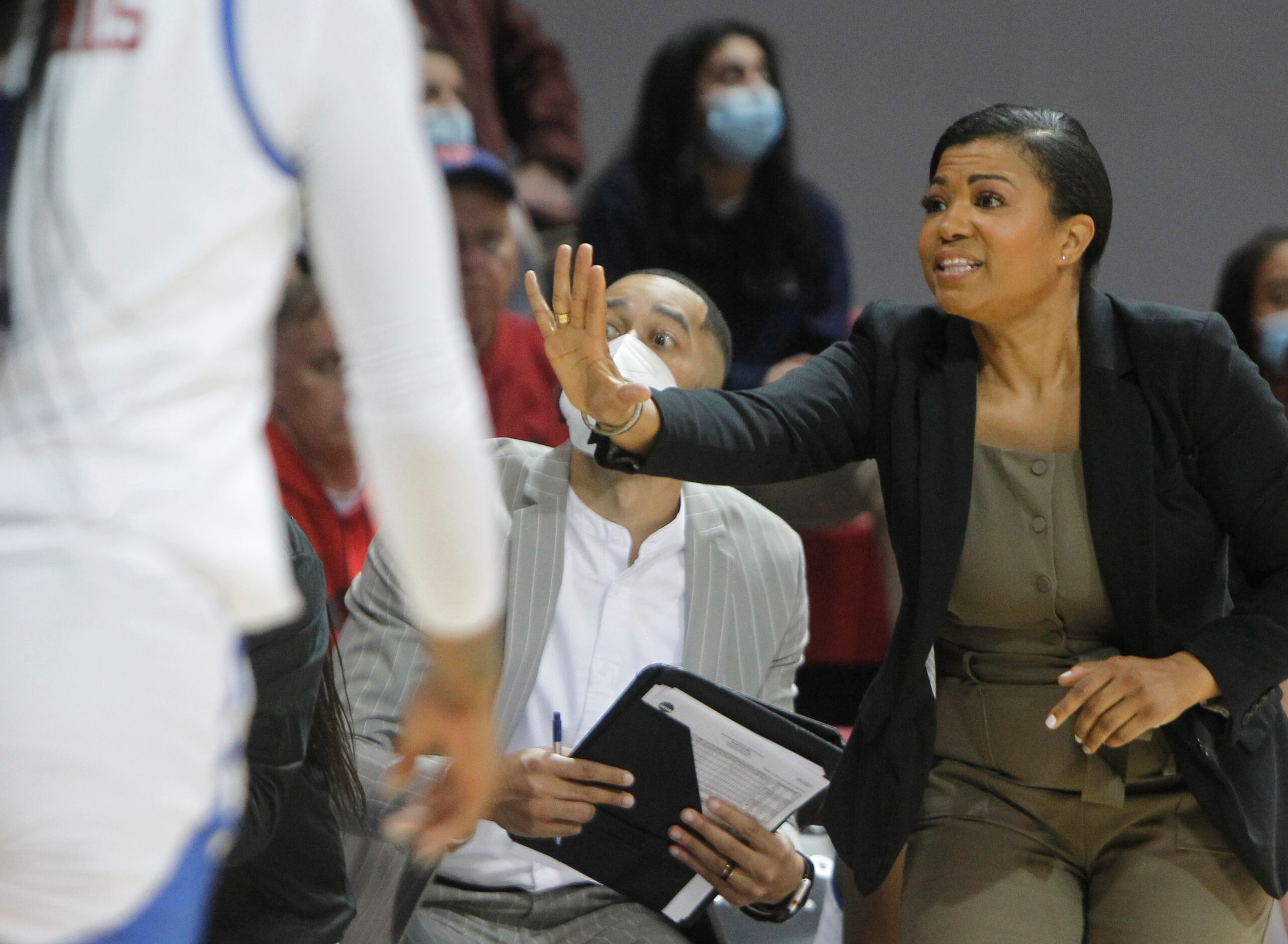 SMU head coach Toyelle Wilson gestures to a player from the team bench area during their...