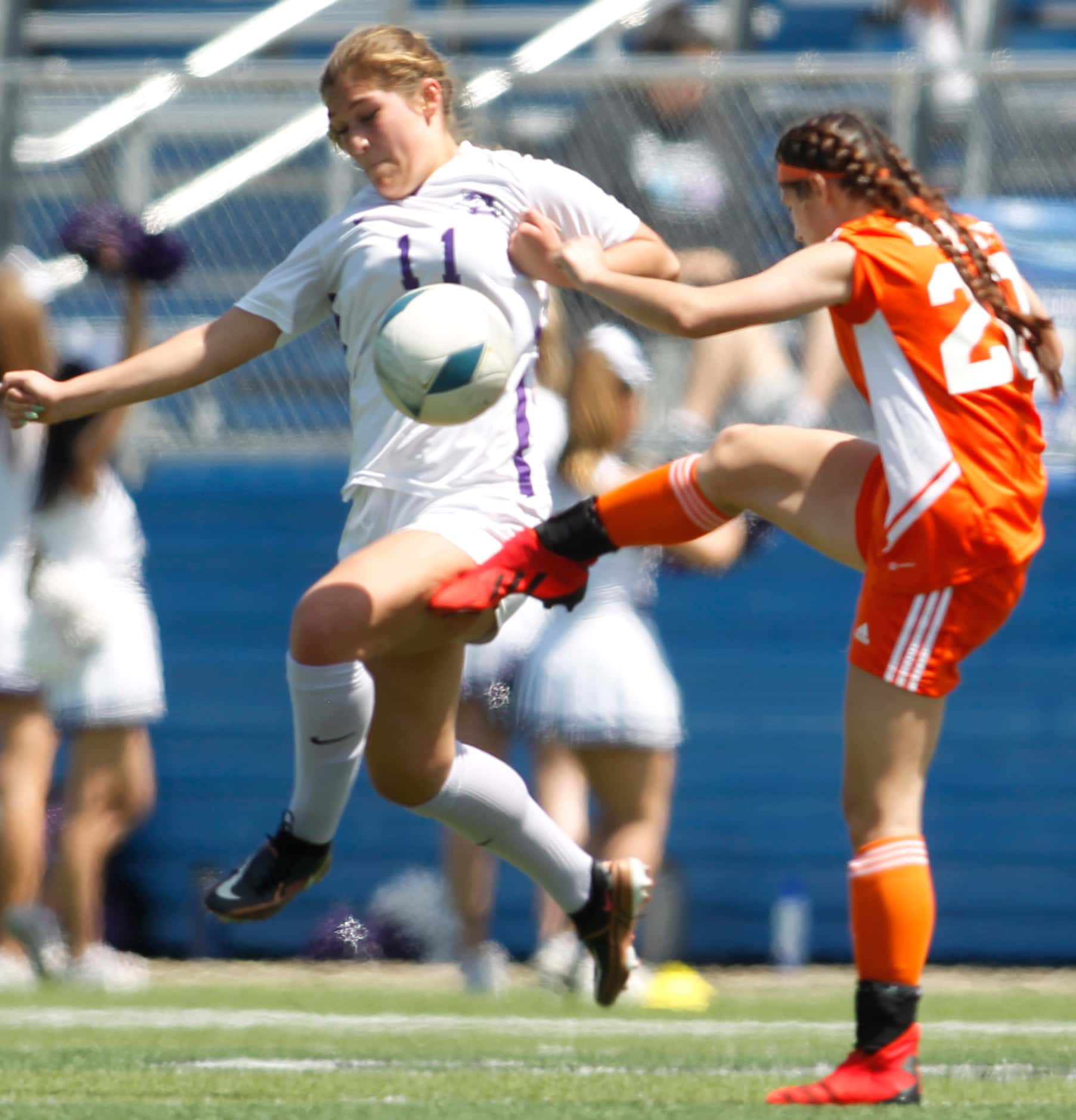 Celina's Ashton Lowry (20) clears a kick in front of Boerne's Samantha Ramirez (11) during...