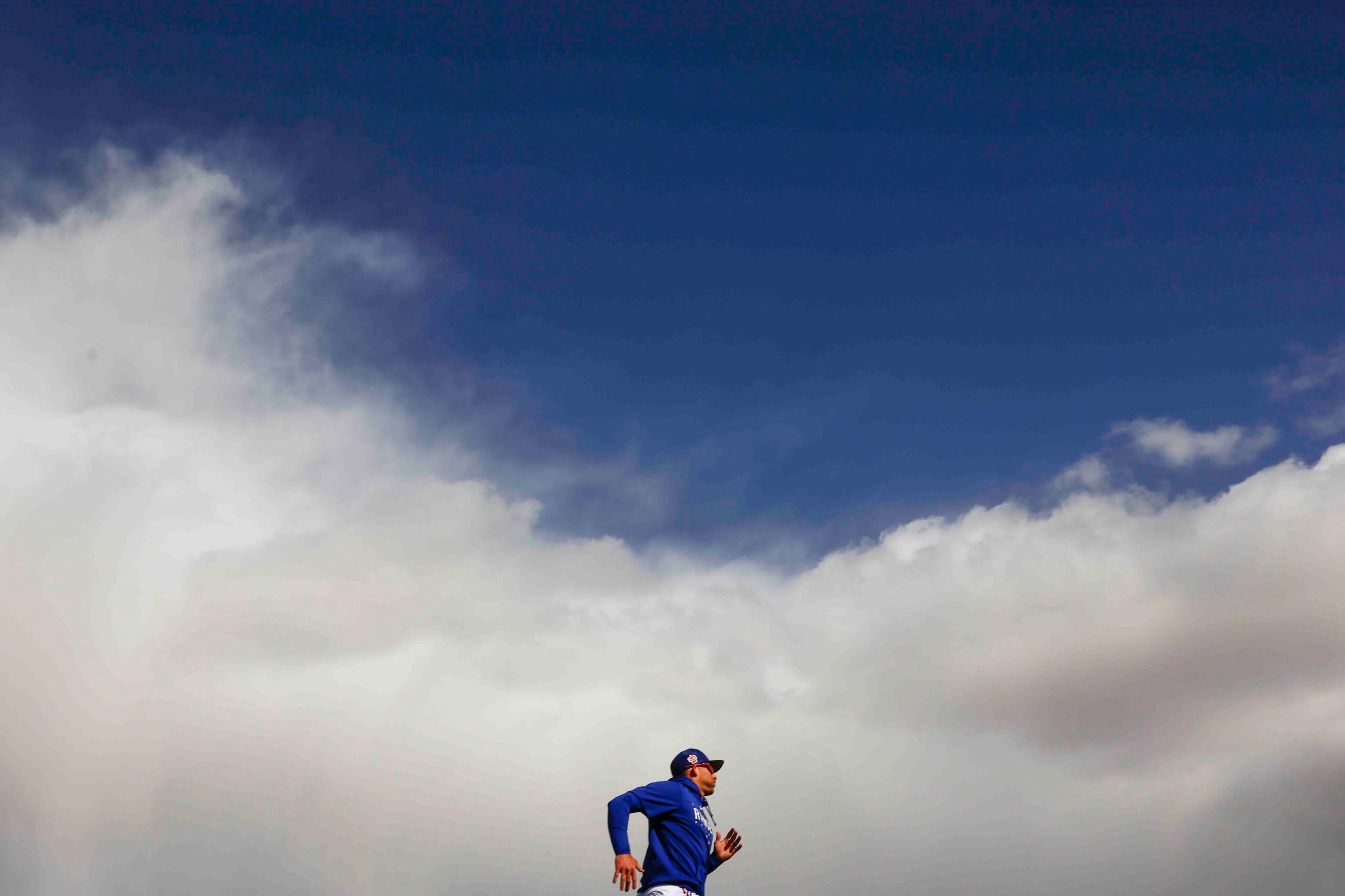 Texas Rangers outfielder Brad Miller runs between bases during a spring training workout at...