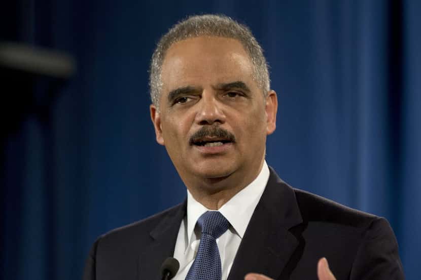 In this 2015 file photo, then-Attorney General Eric Holder speaks at the Justice Department...