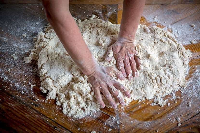 Chef Tim Byres flattens dough he makes buttermilk biscuits at Chicken Scratch restaurant. 