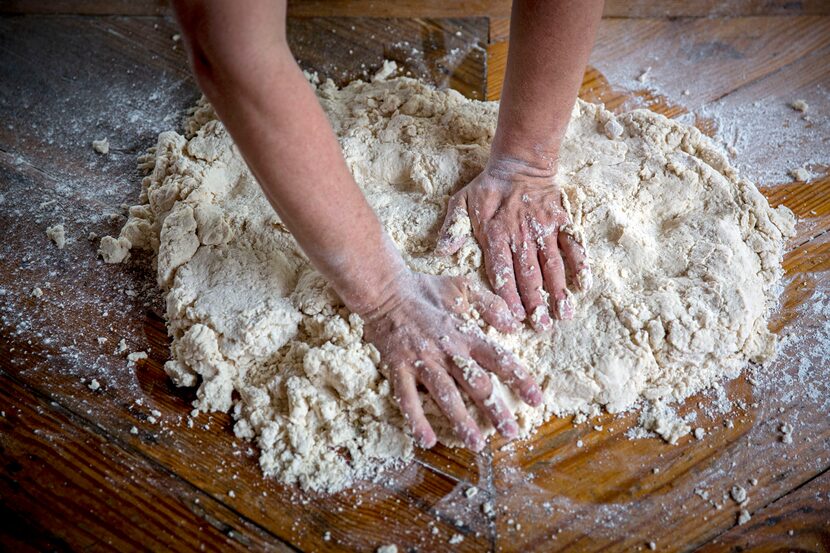 Chef Tim Byres flattens dough he makes buttermilk biscuits at Chicken Scratch restaurant. 