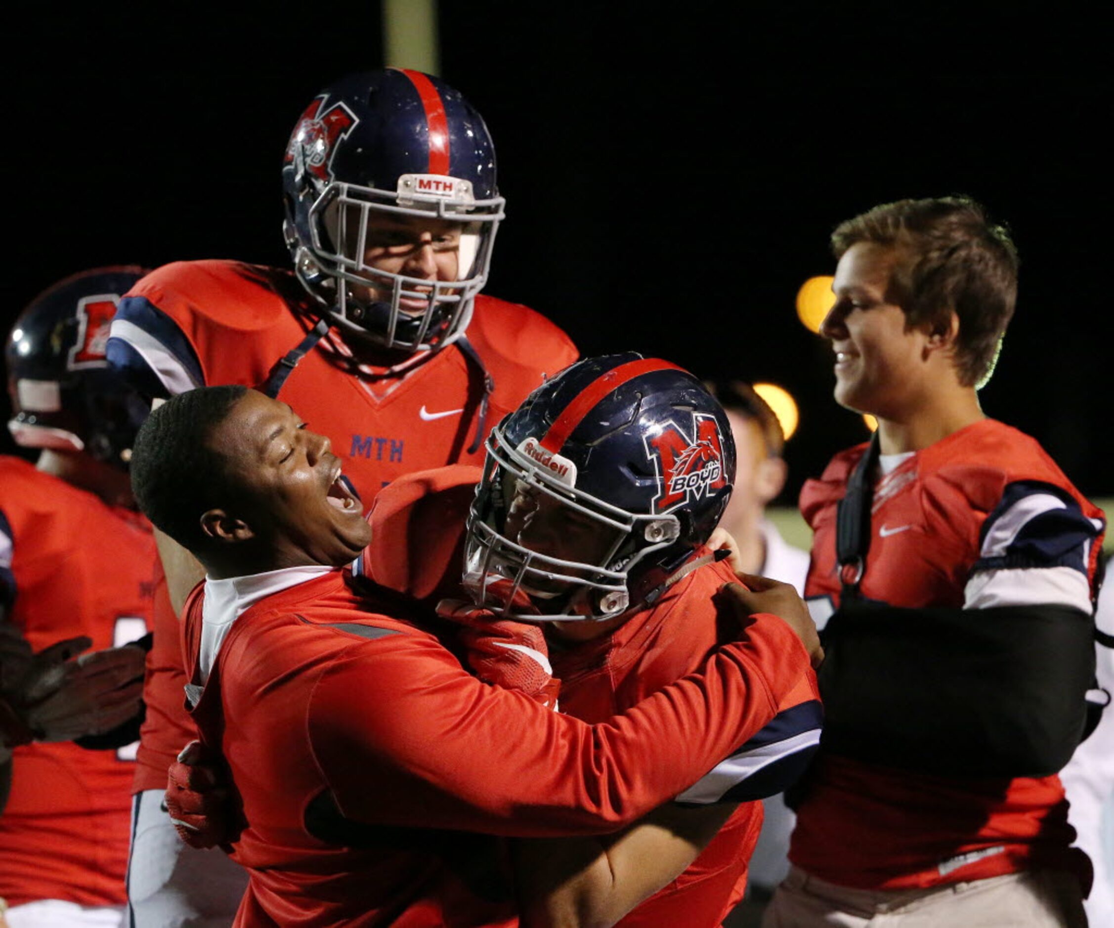 McKinney Boyd assistant coach Robert Boone hugs defensive back Parker Noren (9) after Noren...