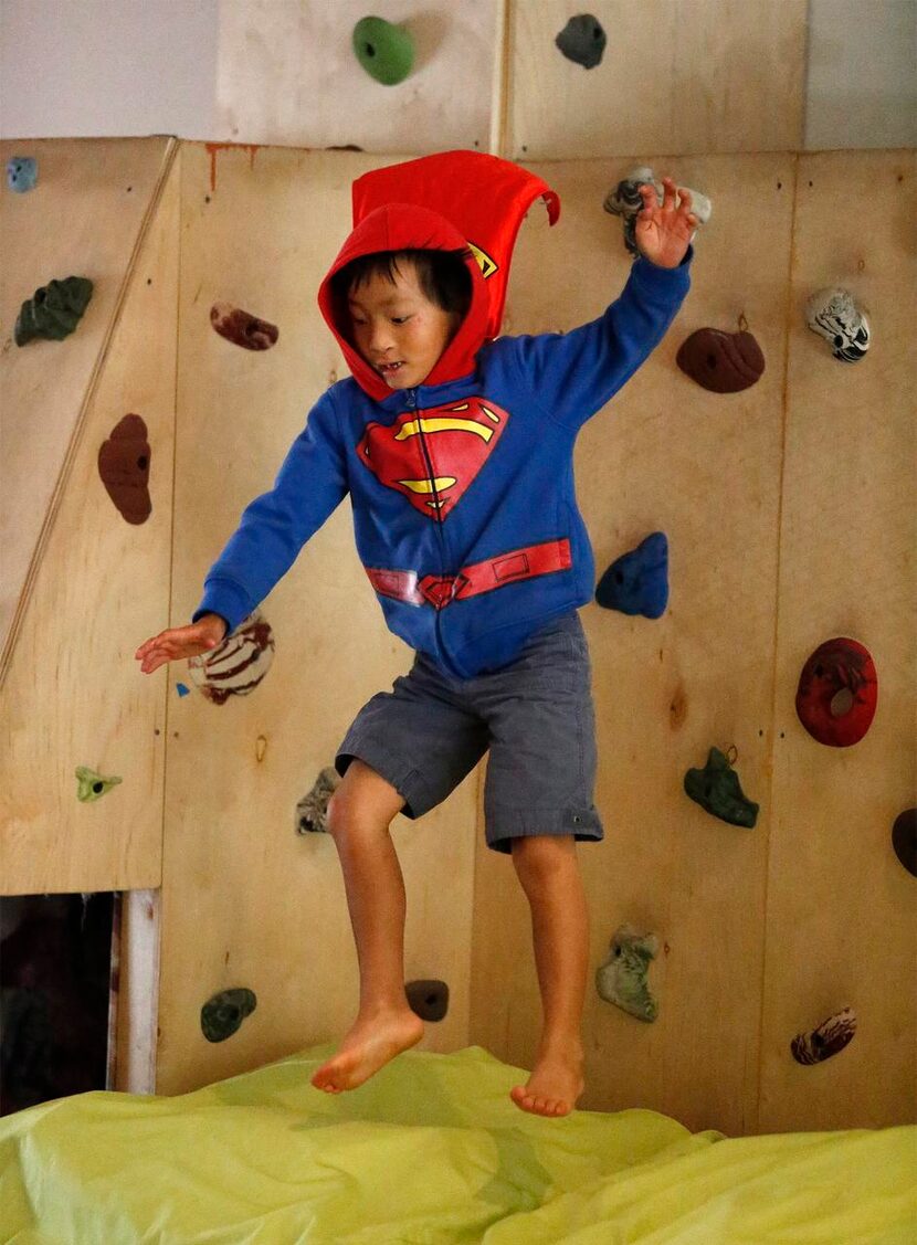 
Quinn Mann, 7, of Dallas, leaps to a cushioned landing in the rec room. 
