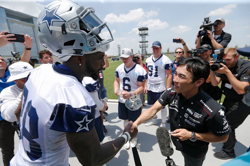 2017 Indy 500 winner Takuma Sato meets Dallas Cowboys wide receiver Dez Bryant (88) after...