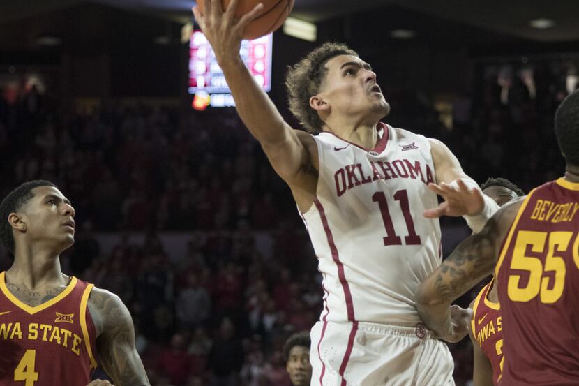 NORMAN, OK - MARCH 2: Oklahoma Sooners guard Trae Young #11 shoots over an Iowa State player...