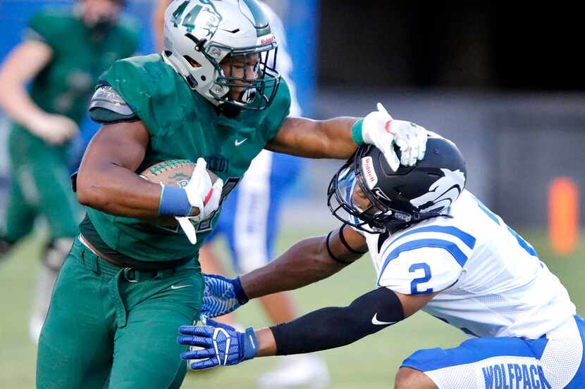 Reedy High School defensive lineman Noah Jackson (44) gives a stiff arm to Plano West High...