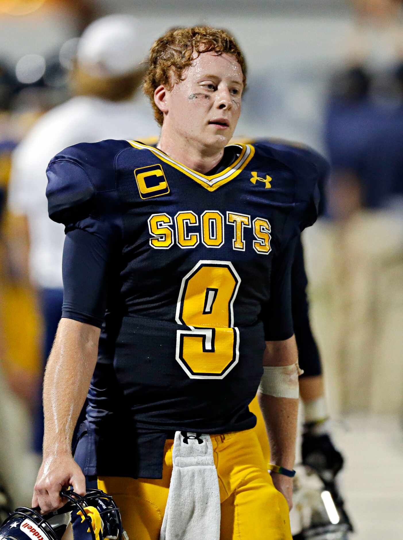 Highland Park quarterback Henry Allen paces the sidelines after an interception late in the...