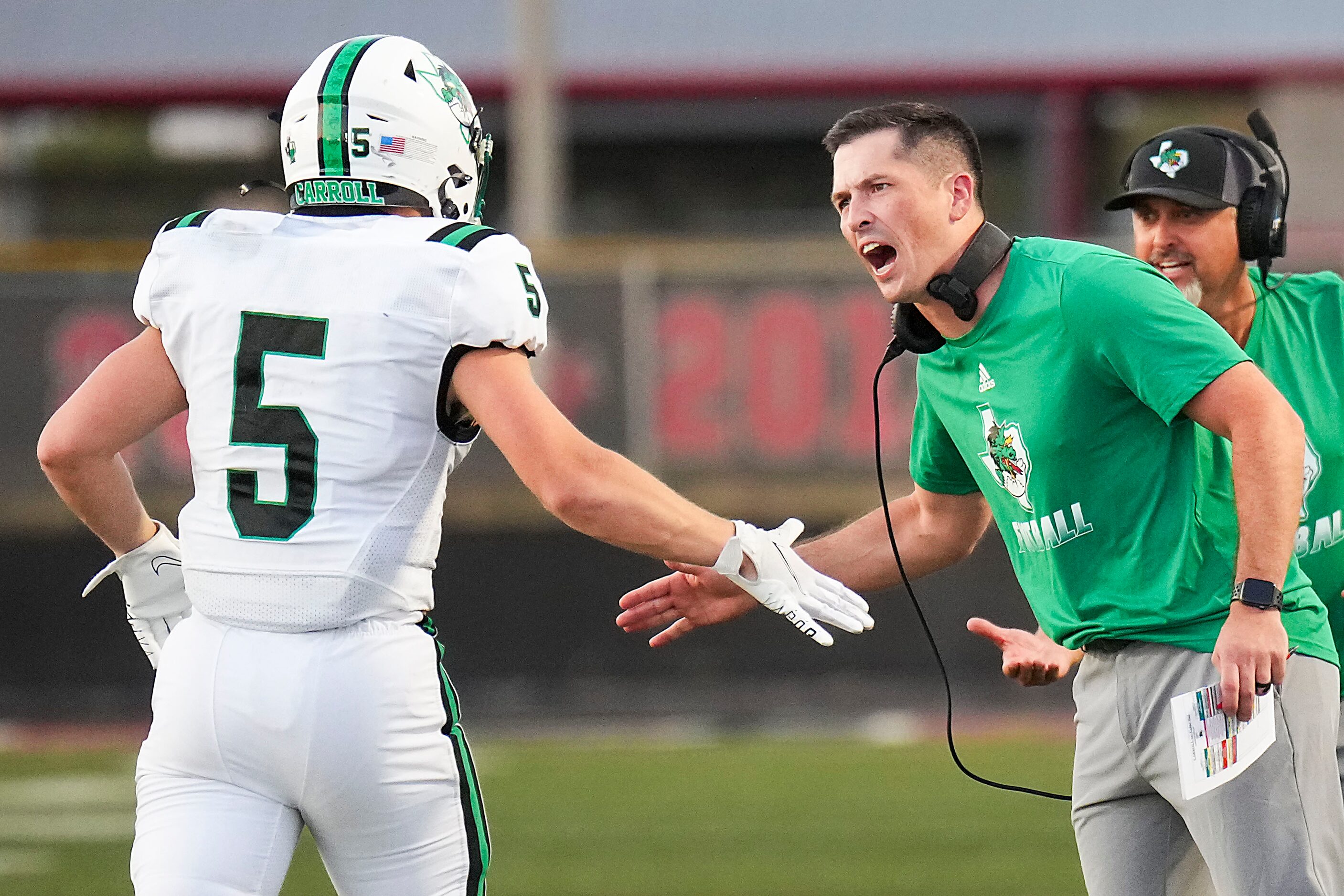 Southlake Carroll head coach Riley Dodge congratulates running back James Lehman (5) after...