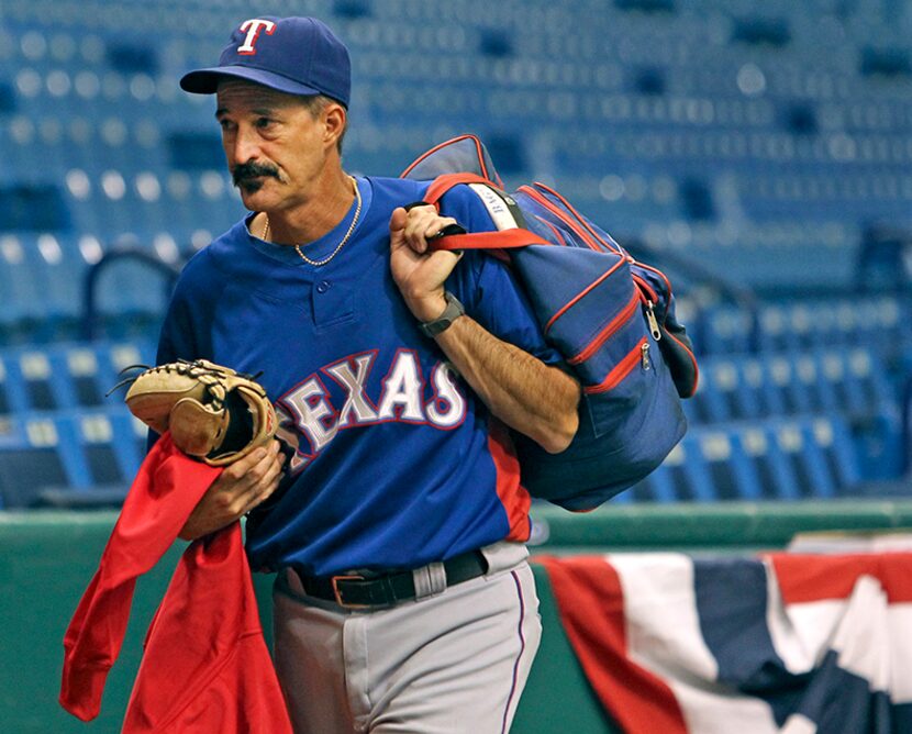  Texas pitching coach Mike Maddux stays busy during Texas Rangers practice before the start...