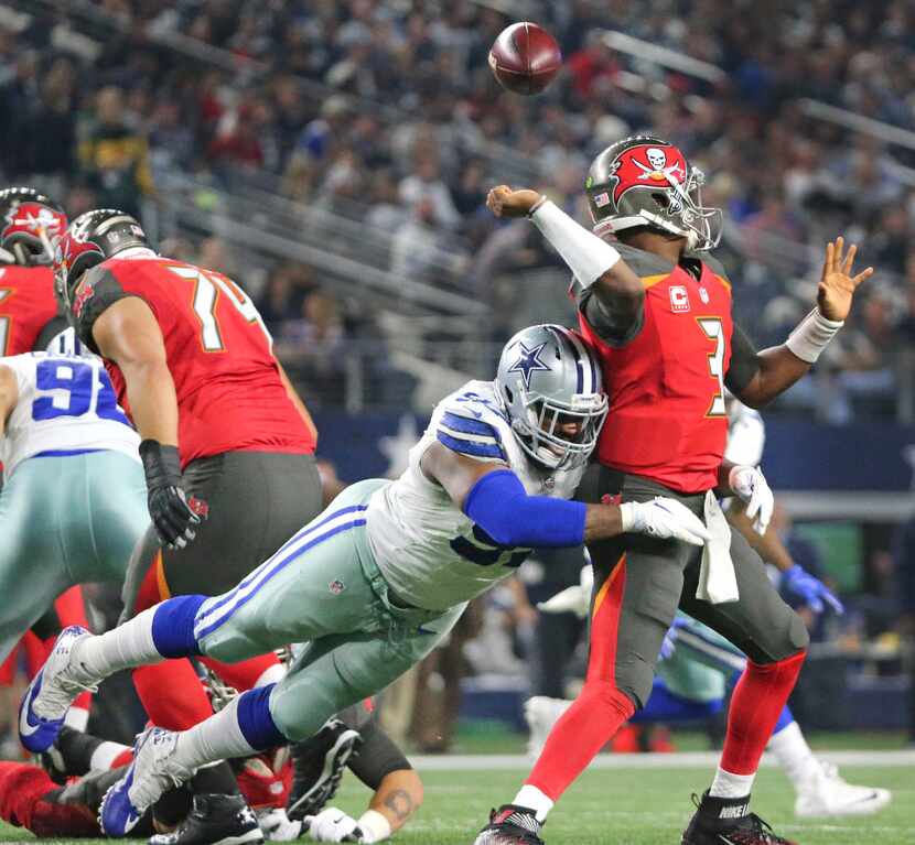 Dallas Cowboys defensive tackle Terrell McClain (97) forces a fumble from Tampa Bay...