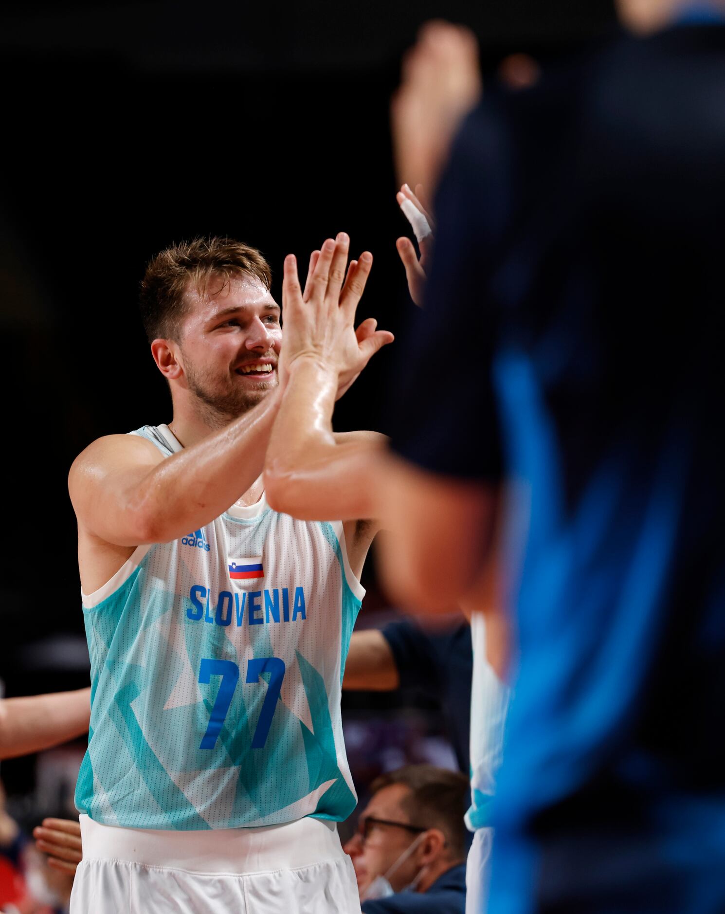 Slovenia’s Luka Doncic is congratulated by teammates as he comes out of the game late in the...